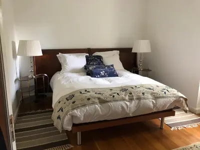 a bedroom with a bed with blue and white pillows at Quintinha de Palmyra in Camacha