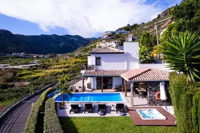 a villa with a swimming pool on a hill at GALVÃO HOUSE EXPERIENCE in Ribeira Brava