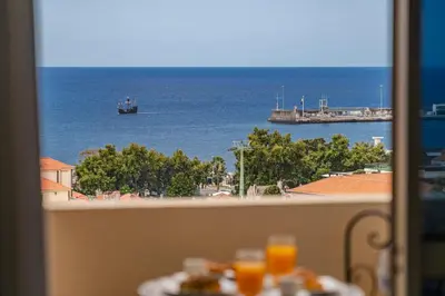 a view of the ocean from a balcony at Alegria III by An Island Apart in Funchal