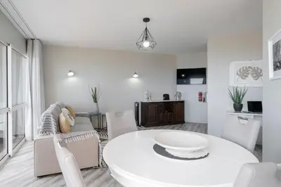 a white living room with a white table and chairs at Alegria III by An Island Apart in Funchal