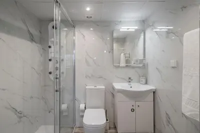 a bathroom with a toilet and a sink and a shower at Alegria III by An Island Apart in Funchal