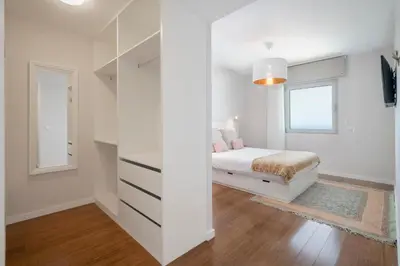 a white bedroom with a bed and a window at Alameda Formosa I by An Island Apart in Funchal