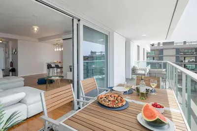 a living room with a table with a pizza on it at Alameda Formosa I by An Island Apart in Funchal