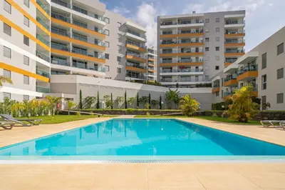 an image of a swimming pool in front of apartment buildings at Alameda Formosa I by An Island Apart in Funchal