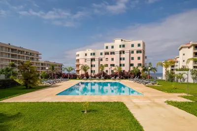 a swimming pool in front of a building at Alameda Formosa I by An Island Apart in Funchal