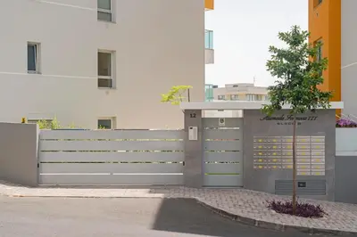 a fence with a tree in front of a building at Alameda Formosa I by An Island Apart in Funchal