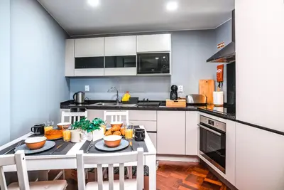 a kitchen with a table with food on it at Rose House By Atlantic Holiday in Machico