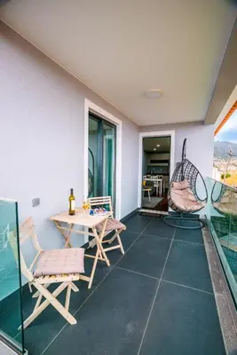 a living room with a table and chairs at Rose House By Atlantic Holiday in Machico