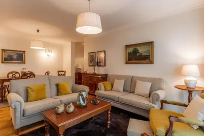 a living room with two couches and a table at Residência Costa do Sol in Funchal