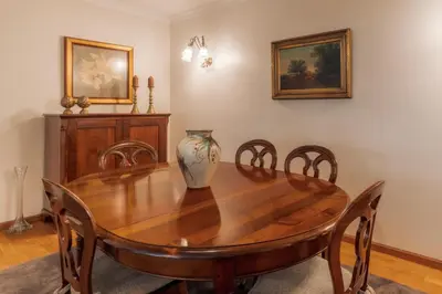 a dining room with a wooden table and chairs at Residência Costa do Sol in Funchal