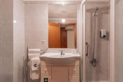 a bathroom with a sink and a shower at Residência Costa do Sol in Funchal