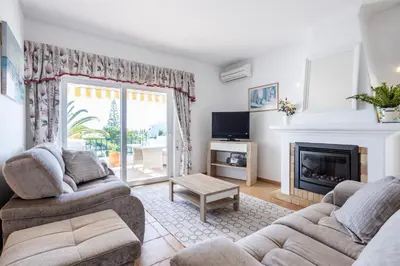 a living room with two couches and a fireplace at Sea Blue Apartment - Luz Ocean Club in Luz