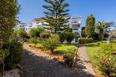 a garden in front of a building at Sea Blue Apartment - Luz Ocean Club in Luz