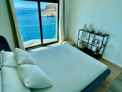 a bedroom with a bed and a large window at Ocean Cliff Apartment in Santa Cruz