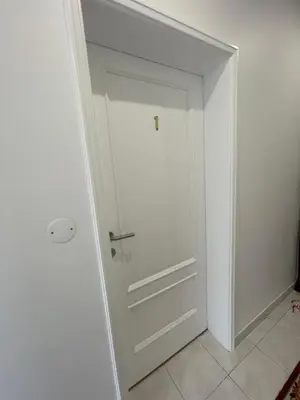 a white door in a room with a tile floor at Sunset House in Arco da Calheta