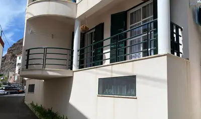 a white building with a balcony on the side of it at The Palms Apartment - Sun & Sea Madeira in Madalena do Mar