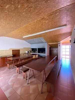 a dining room with wooden tables and benches at The Palms Apartment - Sun & Sea Madeira in Madalena do Mar