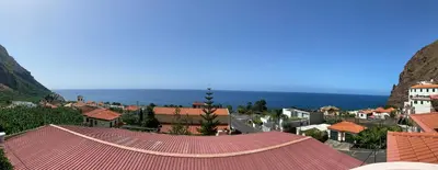 a view of a town with a red roof at The Palms Apartment - Sun & Sea Madeira in Madalena do Mar