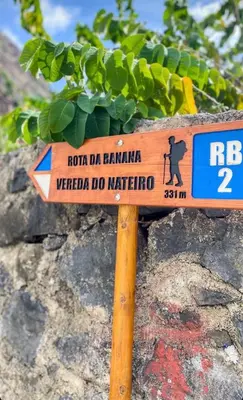 a sign sitting on top of a rock at The Palms Apartment - Sun & Sea Madeira in Madalena do Mar