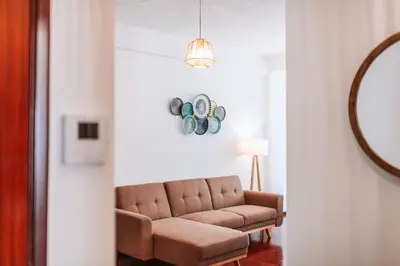 a living room with a couch and a mirror at The Millennial Lifestyle Apartment by Amazing Madeira in Funchal