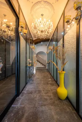 a hallway with a yellow vase and a chandelier at Le Vingale in Funchal