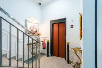 a hallway with a red door and stairs at Le Vingale in Funchal