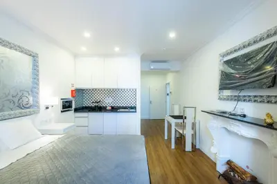 a large white kitchen with a table and a counter at Le Vingale in Funchal