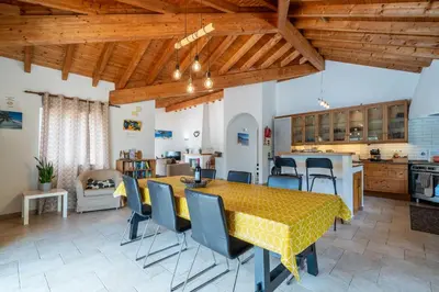 a kitchen and dining room with a table and chairs at Casa Garrod - Spacious Family Villa in Aljezur