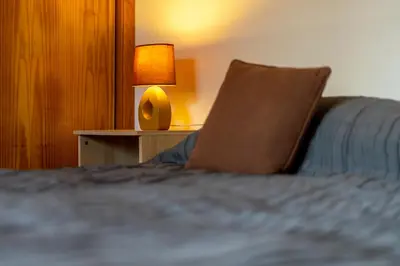 a bed with a pillow and a lamp on a table at Casa Garrod - Spacious Family Villa in Aljezur