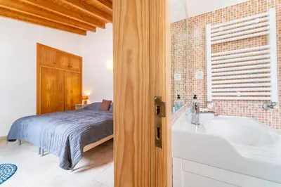 a bedroom with a bed and a bath tub next to a bed at Casa Garrod - Spacious Family Villa in Aljezur