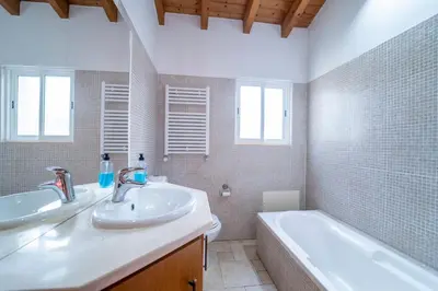 a bathroom with two sinks and a bath tub at Casa Garrod - Spacious Family Villa in Aljezur