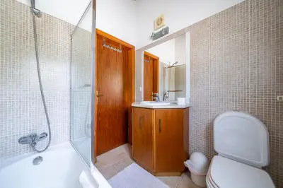 a bathroom with a tub and a toilet and a sink at Casa Garrod - Spacious Family Villa in Aljezur