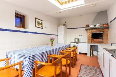 a kitchen with a table and chairs in a room at Villa Dinis by Holiday Rental Madeira in Calheta
