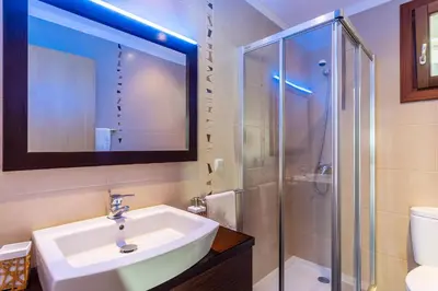 a bathroom with a sink and a shower at Villa Dinis by Holiday Rental Madeira in Calheta