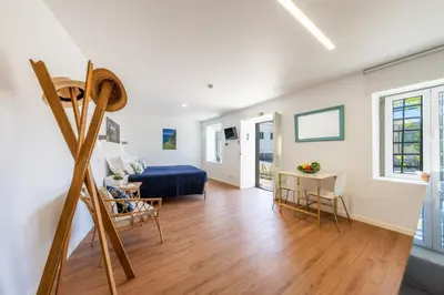 a living room with a bed and a table at Casa Amarela Apartments - by Casas na Ilha in Câmara de Lobos