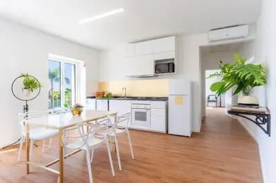 a kitchen and dining room with a table and chairs at Casa Amarela Apartments - by Casas na Ilha in Câmara de Lobos