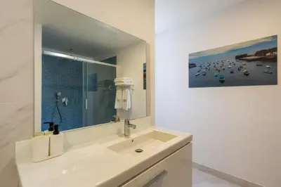 a white bathroom with a sink and a mirror at Casa Amarela Apartments - by Casas na Ilha in Câmara de Lobos