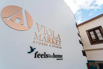 a sign for a woola market store and stores at FLH Viola Market Studios in Funchal