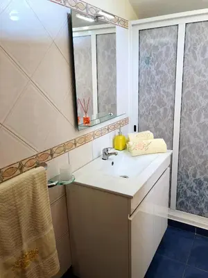 a bathroom with a sink and a mirror at Casa AIDA SEA VIEW in Relógio do Poiso
