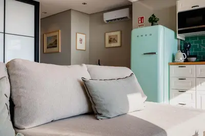 a living room with a couch and a blue refrigerator at Rooftop Funchal I by Madeira Best Apartments in Funchal