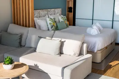 a living room with a bed and a couch at Rooftop Funchal I by Madeira Best Apartments in Funchal