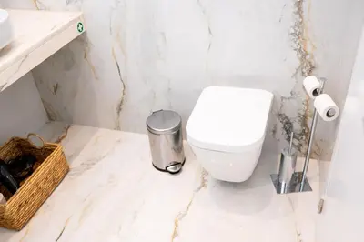 a bathroom with a toilet and a trash can at Rooftop Funchal I by Madeira Best Apartments in Funchal