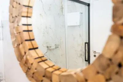 a mirror in front of a bathroom door at Rooftop Funchal I by Madeira Best Apartments in Funchal
