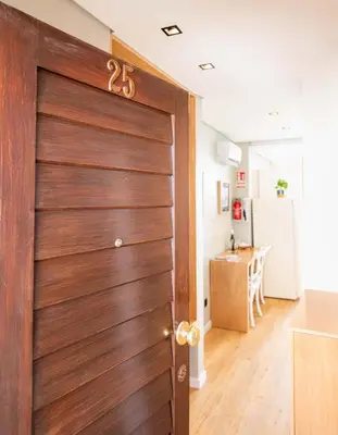a wooden door in a room with a kitchen at Rooftop Funchal II by Madeira Best Apartments in Funchal