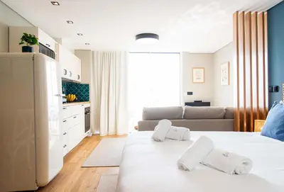 a living room with two beds and a kitchen at Rooftop Funchal II by Madeira Best Apartments in Funchal