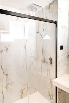 a shower with a glass door in a bathroom at Rooftop Funchal II by Madeira Best Apartments in Funchal