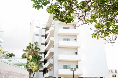 a white building with trees in front of it at Rooftop Funchal II by Madeira Best Apartments in Funchal