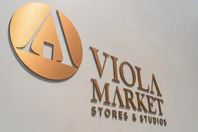 a sign for a wool market stores and suites at FLH Viola Market Flats in Funchal