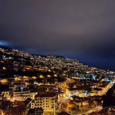 a view of a city at night with lights at Chalé Funchal - City view in Funchal