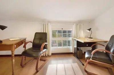 a bedroom with a large bed and a window at Casa Amarela in Caniço